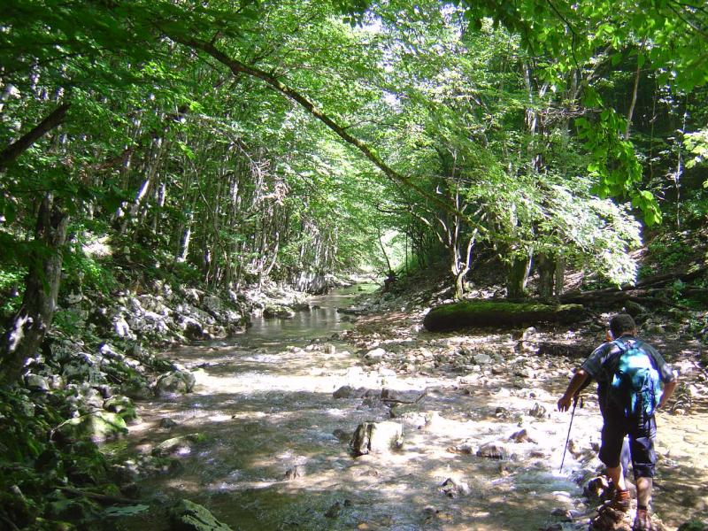 Wanderer überquert Fluss