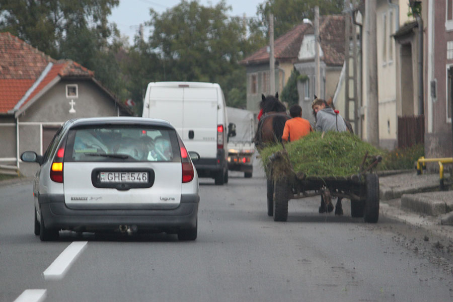 Autos überholen Pferdefuhrwerk