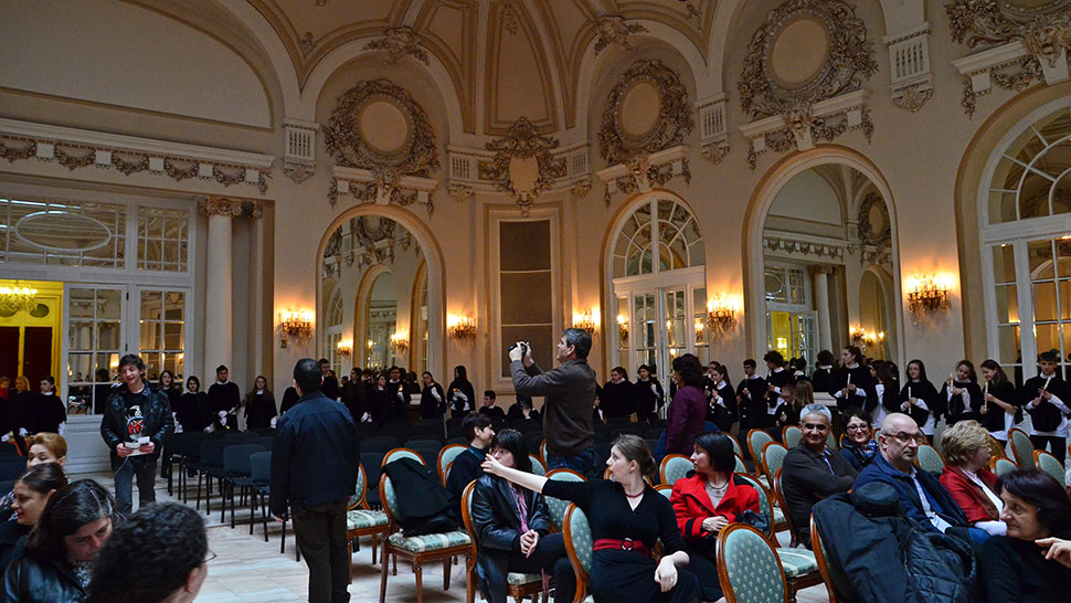 Kinder stehen in einem Barocksaal mitten im Publikum