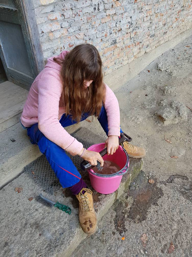 Mädchen putzt Glockenklöppel