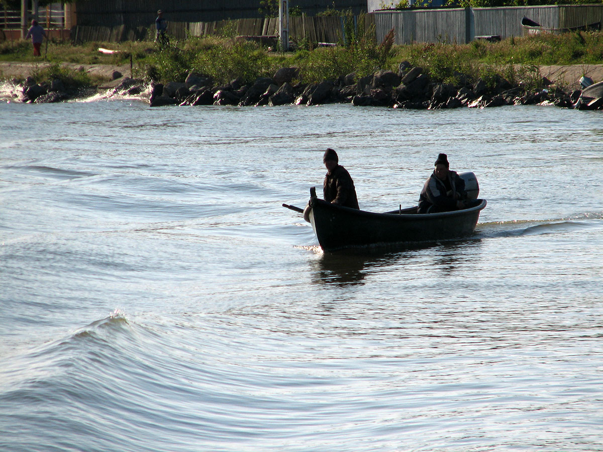 Fischeboot mit zwei Männern fährt auf der Donau