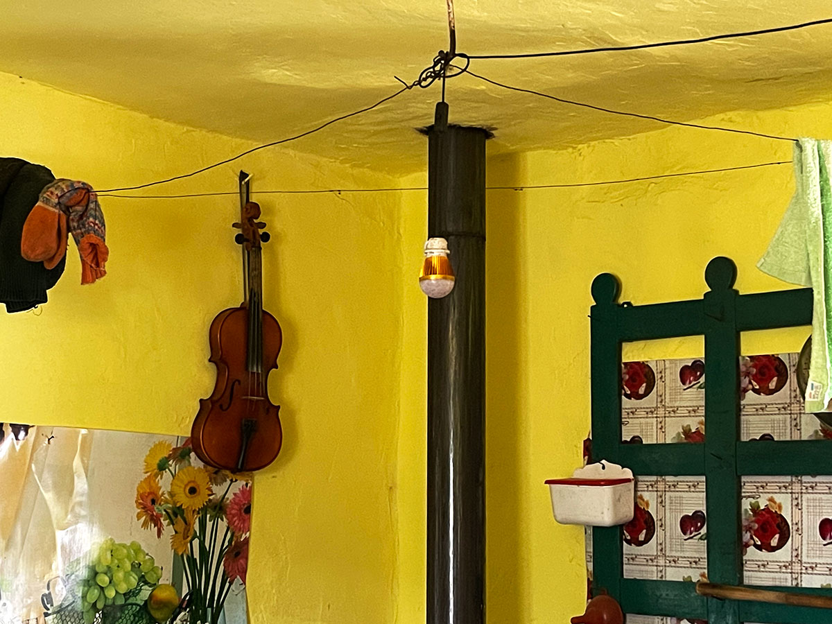 Geige hängt an einer gelben Wand